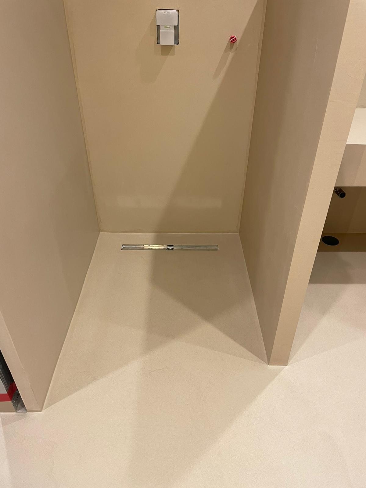 Close-up of real microcement linear drain flush finish, fitted by our team