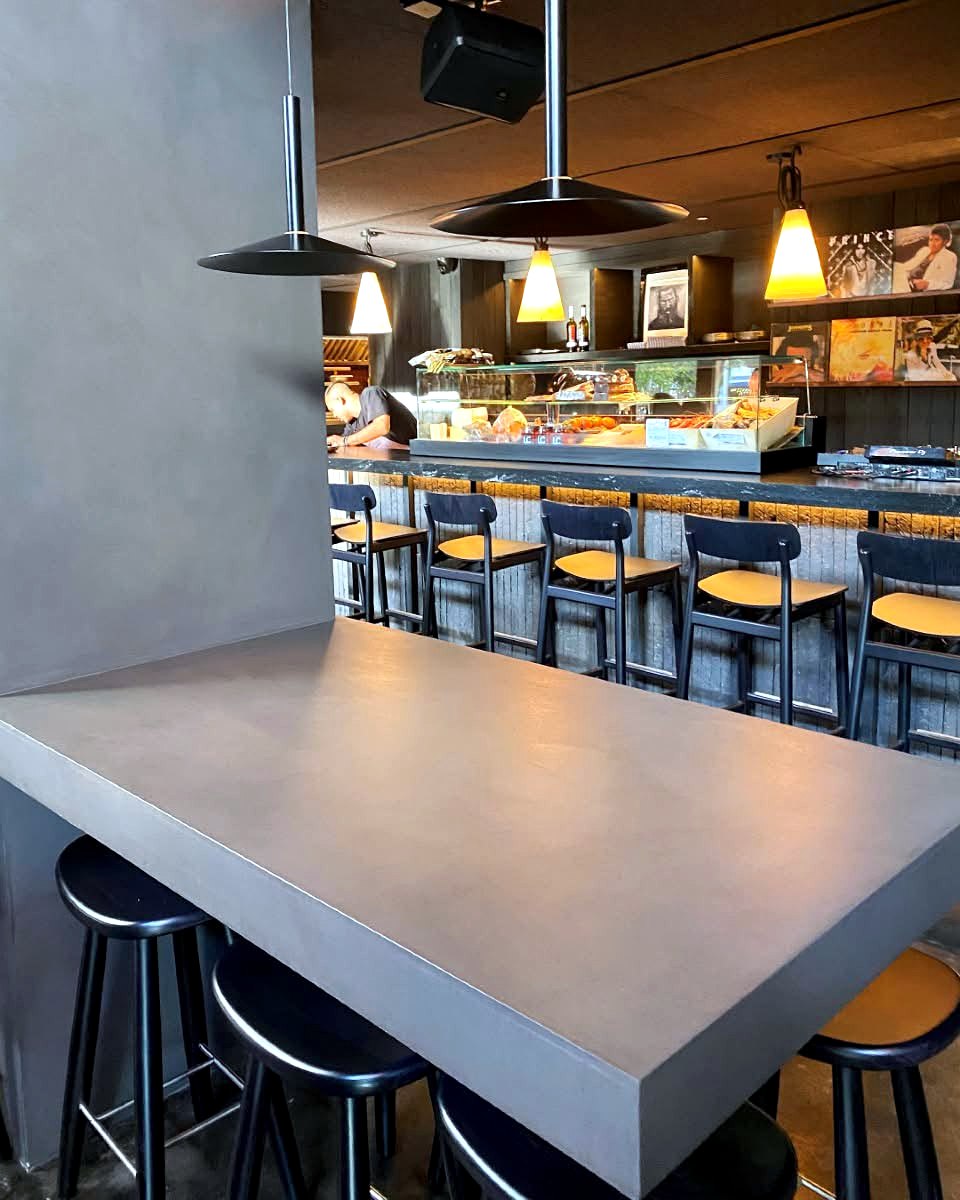 Commercial bar and cafe counter finished in microcement, hospitality fit-out